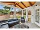 Inviting screened-in porch with outdoor seating and views of the backyard and privacy fence at 10300 Medridge Cir, Johns Creek, GA 30022