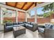 Comfortable screened-in porch featuring outdoor seating and views of the backyard and privacy fence at 10300 Medridge Cir, Johns Creek, GA 30022