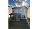View of backyard with covered patio area and well-maintained lawn, great for outdoor entertaining at 1923 Westfall Lndg, Auburn, GA 30011