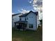 Picture of backyard showing the covered patio and landscaping on a partly cloudy day at 1923 Westfall Lndg, Auburn, GA 30011