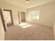 Clean, well-lit bedroom with neutral carpet and a large window at 1923 Westfall Lndg, Auburn, GA 30011