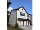Side angle view of a home with two-car garage, landscaped with a fresh aesthetic at 1923 Westfall Lndg, Auburn, GA 30011