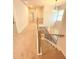 Well-lit stairway with carpet and wood railing leading to the upper level at 1923 Westfall Lndg, Auburn, GA 30011