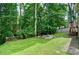 Backyard fire pit with seating is perfect for gatherings and relaxation surrounded by lush trees at 2212 Mcquiston Sw Dr, Marietta, GA 30064