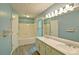 Bright bathroom with a double sink vanity, bathtub, and walk-in shower at 2212 Mcquiston Sw Dr, Marietta, GA 30064