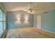 Spacious bedroom with ceiling fan, carpet floors, and two bedside lamps at 2212 Mcquiston Sw Dr, Marietta, GA 30064