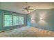 Comfortable bedroom with carpet floors, two lamps, and large windows at 2212 Mcquiston Sw Dr, Marietta, GA 30064