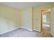 This carpeted bedroom features neutral walls and access to another room at 2212 Mcquiston Sw Dr, Marietta, GA 30064