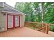 Lovely deck with wooden railings and double doors offers serene views of the surrounding lush greenery at 2212 Mcquiston Sw Dr, Marietta, GA 30064