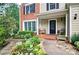 Close-up of a home with a front porch featuring chairs and lush plants at 2212 Mcquiston Sw Dr, Marietta, GA 30064