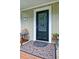 Close up of front door with a decorated porch with a mat and furniture at 2212 Mcquiston Sw Dr, Marietta, GA 30064