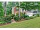Charming home with mature trees and colorful landscaping in front yard at 2212 Mcquiston Sw Dr, Marietta, GA 30064