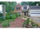Beautifully landscaped front yard with lush greenery and stone accents at 2212 Mcquiston Sw Dr, Marietta, GA 30064