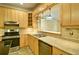 Bright kitchen featuring stainless steel appliances, light wood cabinetry and tile flooring at 2212 Mcquiston Sw Dr, Marietta, GA 30064