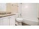 Bathroom showcasing a granite countertop, white cabinets, and a shower-tub combination at 2912 Springside Se, Atlanta, GA 30354