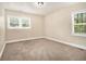 Cozy bedroom featuring neutral walls, carpet flooring, and natural light from two windows at 2912 Springside Se, Atlanta, GA 30354