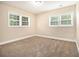 Neutral bedroom featuring carpet, two windows, and baseboard trim at 2912 Springside Se, Atlanta, GA 30354