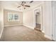 Cozy bedroom with neutral carpet, a ceiling fan and painted white brick accent wall at 2912 Springside Se, Atlanta, GA 30354