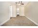 Spacious bedroom with neutral carpet, a ceiling fan and painted white brick accent wall at 2912 Springside Se, Atlanta, GA 30354