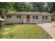 Charming single-story home with a well-manicured lawn and a bright red front door at 2912 Springside Se, Atlanta, GA 30354