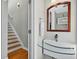 Modern bathroom with a glass shelf sink, hardwood floors, and stairs leading up to the second floor at 3541 Roswell Ne Rd # 21, Atlanta, GA 30305