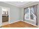 Bedroom with light walls and hardwood floors leads to an ensuite bath at 3541 Roswell Ne Rd # 21, Atlanta, GA 30305