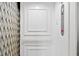In-home elevator with diamond pattern flooring, featuring a white frame and metal accordion door at 3541 Roswell Ne Rd # 21, Atlanta, GA 30305