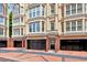 Exterior facade showing private garages, brick columns and detailed architecture of the townhome at 3541 Roswell Ne Rd # 21, Atlanta, GA 30305