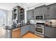 Open kitchen featuring stainless steel appliances, gray cabinets, and an island for cooking and entertaining at 3541 Roswell Ne Rd # 21, Atlanta, GA 30305