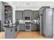 Kitchen featuring gray cabinets, stainless steel appliances and hardwood floors throughout the space at 3541 Roswell Ne Rd # 21, Atlanta, GA 30305