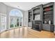Bright and spacious living room featuring a fireplace, built-in shelving, and large arched windows at 3541 Roswell Ne Rd # 21, Atlanta, GA 30305