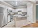 Bright kitchen features white cabinets, granite countertops, stainless steel appliances, and a center island at 1850 Cotillion Dr # 3305, Dunwoody, GA 30338