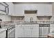 Bright kitchen features stainless steel appliances, white cabinets, and granite countertops at 1850 Cotillion Dr # 3305, Dunwoody, GA 30338
