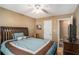 Bedroom featuring a bed with a blue comforter, a ceiling fan, and a doorway leading to another room at 1951 Chambers Rd, Mcdonough, GA 30253