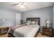 Bedroom featuring an exercise bike, neutral decor, a ceiling fan, and a window for natural light at 1951 Chambers Rd, Mcdonough, GA 30253