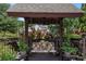 Covered deck swing surrounded by potted plants and flowers at 1951 Chambers Rd, Mcdonough, GA 30253