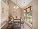 Bright dining room offers natural light, stylish table with seating for six, and vaulted ceilings, ideal for Gathering meals at 1951 Chambers Rd, Mcdonough, GA 30253