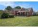 View of a charming two-story house with inviting front porch and beautifully landscaped yard at 1951 Chambers Rd, Mcdonough, GA 30253