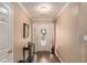 Entryway with wood floors, decor table, and front door with decorative wreath at 1951 Chambers Rd, Mcdonough, GA 30253