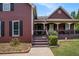 Inviting front porch with cozy seating offers a charming welcome to the home at 1951 Chambers Rd, Mcdonough, GA 30253