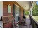 Charming front porch decorated with rustic furniture and decorative welcome sign at 1951 Chambers Rd, Mcdonough, GA 30253