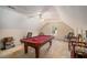 Attic game room with a pool table, a ceiling fan, and natural light from the window at 1951 Chambers Rd, Mcdonough, GA 30253