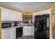 Efficient kitchen boasts white cabinets, modern appliances, and a functional layout, making meal preparation a breeze at 1951 Chambers Rd, Mcdonough, GA 30253