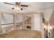 Spacious loft area with neutral walls, a white railing, and natural light from the windows at 1951 Chambers Rd, Mcdonough, GA 30253