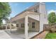 View of the home's back exterior with a covered patio and fenced-in yard at 4546 Water Mill Dr, Buford, GA 30519