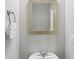 Stylish powder room featuring a decorative mirror and modern fixtures at 4546 Water Mill Dr, Buford, GA 30519