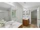 Bright bathroom featuring double vanity, large mirror, separate tub and shower at 4546 Water Mill Dr, Buford, GA 30519