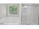 This bathroom features a bathtub and shower at 4546 Water Mill Dr, Buford, GA 30519