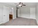 This bedroom has a ceiling fan and open doors to an adjoining bathroom and closet at 4546 Water Mill Dr, Buford, GA 30519