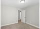 This bedroom features neutral walls, carpet flooring, and ample natural light from the doors at 4546 Water Mill Dr, Buford, GA 30519